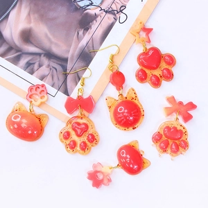 Glittery red cat paw and moon pendant earrings made with DIY silicone molds