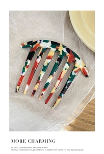 Close-up of a 7-tooth acetate hair comb with unique multicolor mosaic marble patterns