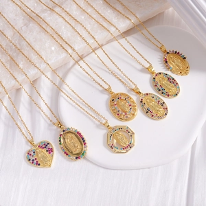 Golden Virgin Mary necklaces with colorful zircon accents on white marble display