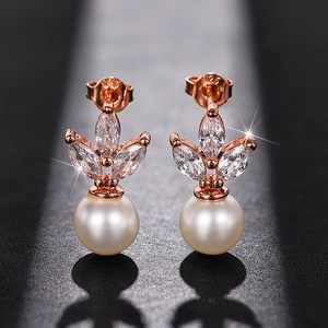 Detail of rose gold earring with marquise cubic zirconia and a round white pearl