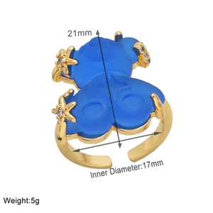 Detail view of adjustable gold-plated ring with blue bear motif and size dimensions