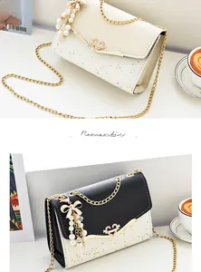 Detail of elegant shoulder bag with sparkling star patterns and a heart-shaped diamond buckle
