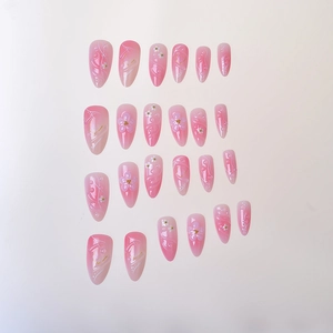 Pink gradient almond press-on nails featuring 3D floral relief and pearl decorations