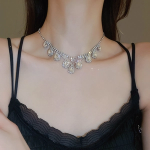 Close-up of sparkling rhinestone waterdrop fringe necklace set on model neck