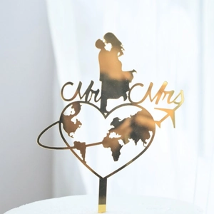 Gold Mr & Mrs acrylic cake topper with kissing couple and world map heart detail