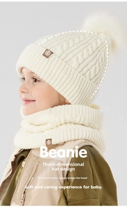 Detailed cable knit texture and faux fur pom-pom on kids winter warm beanie hat and scarf