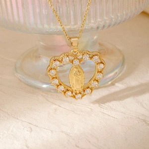 Macro shot of 18K gold heart pendant featuring Virgin Mary relief and white zircon inlay