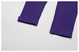Detailed close-up of dark purple yoga pants featuring reinforced seamless stitching