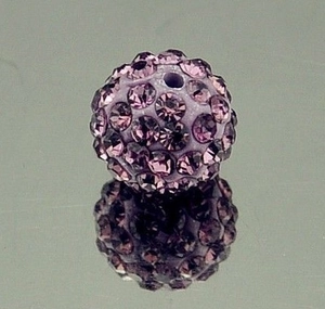 Macro shot of an 8mm purple crystal disco ball bead with sparkling rhinestones for DIY crafts