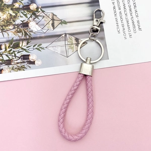 Pink braided leather keychain with metal ring and spring hook on decorative card
