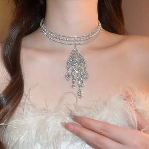 Detailed view of luxury triple-layer choker with rhinestones, pearls and fringe pendant