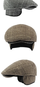 Detail of vintage plaid duckbill hat featuring foldable earflaps and thick wool texture