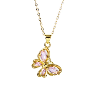 Close-up of golden butterfly pendant with four sparkling pink gemstones on a fine chain