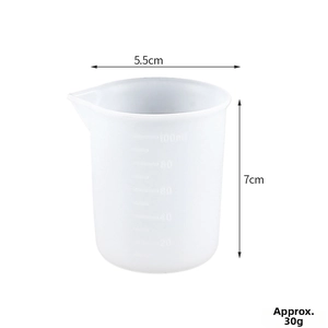 Close-up of 100ml silicone measuring cup showing 20-100ml embossed scales and pour spout