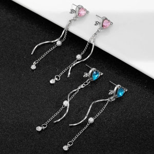 Detail of Cupid heart tassel earrings with pink and blue stones and pearl accents