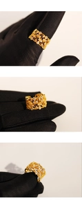 Macro view of gold lace-patterned ring featuring drop zircon stones and hollow details