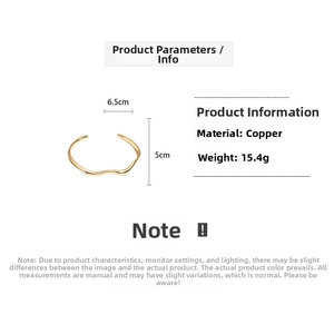 Detail view of 18k gold plated wave bangle showing dimensions 6.5cm by 5cm and 15.4g weight
