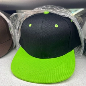Detail of a black and neon green snapback hat featuring a six-panel twill construction