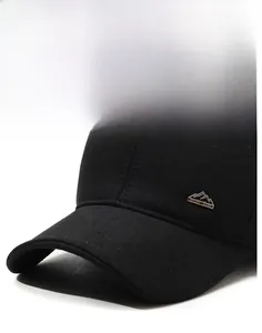 Detail of wool baseball cap with peak metal logo engraving and textured black fabric