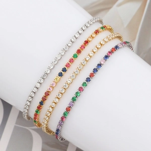 Close-up of four assorted colorful zircon tennis bracelets displayed on white pillar
