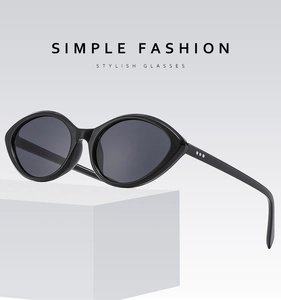 Detail of chic cat eye sunglasses with silver accents on white geometric block