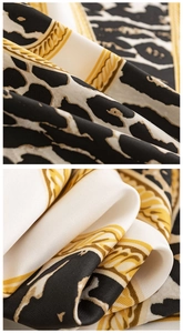 Macro shot of silk-like leopard print scarf featuring golden chain details and texture