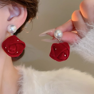 Detail of red flocked rose earrings with white pearls and sparkling diamond edges