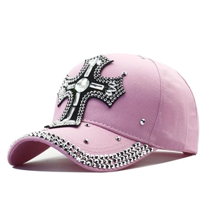 Pink Y2K baseball cap with rhinestone cross and jewels shown at a 45-degree angle