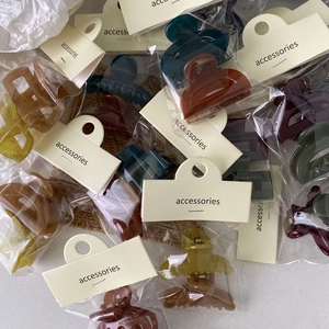 Macro shot of assorted colorful jelly hair clips in individual packaging with cards