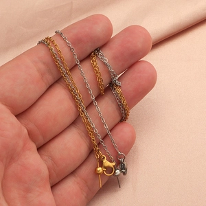 Detail of gold and silver stainless steel beaded chains with lobster clasps and pins