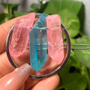 Detailed view of silver hair clip featuring pink and blue raw natural crystal stones