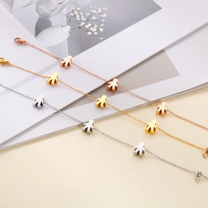 Minimalist stainless steel chain bracelet with human figure pendants in gold, rose gold and silver