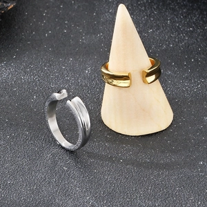 Minimalist V-groove stainless steel open rings in gold and silver finishes on display