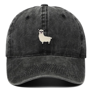 Detailed view of white alpaca embroidery on washed black denim baseball cap