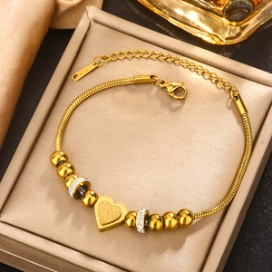 Detailed close-up of gold-plated stainless steel heart pendant on adjustable snake chain