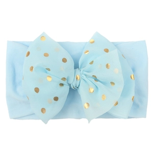 Light blue nylon baby headband featuring a large gold polka dot mesh bow decoration