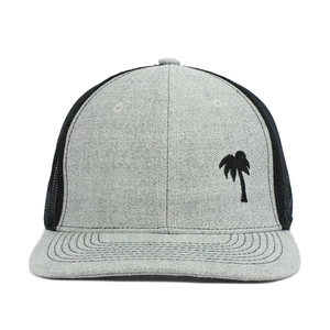 Close-up of coconut tree embroidery and mesh detail on a flat-brimmed snapback hat