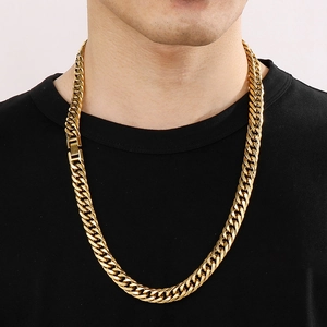 Close-up of a 12mm golden titanium steel curb chain necklace worn by a male model
