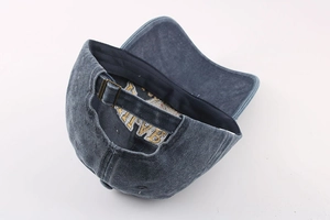 Detail of adjustable metal buckle and vintage washed cotton fabric on the baseball cap