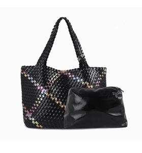 Detail of black woven tote bag with rainbow metallic stripes and matching clutch bag