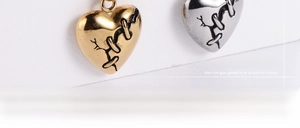 Macro shot of vintage heart pendants in gold and silver with unique stitched texture