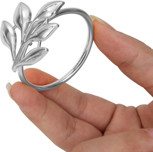 Single silver alloy maple leaf napkin ring shown held by hand on white background