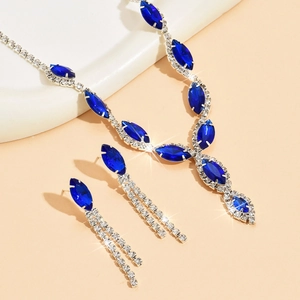Macro shot of bridal jewelry set with navy marquise stones and teardrop tassels