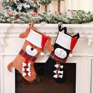 Creative dog and cat Christmas stockings hanging on a white fireplace mantel decoration