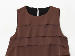 Close-up of tiered ruffle details and button back closure on brown satin top