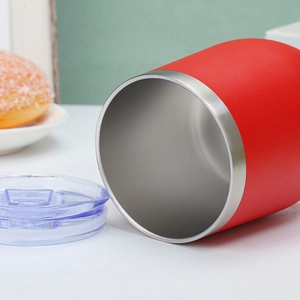 Detail of red stainless steel egg cup showing the brushed rim and smooth interior lining