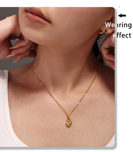 Wearing effect of golden heart lock necklace with blue stone and rainbow hoop earrings