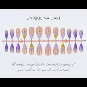 Detailed view of almond-shaped purple press-on nails with 3D shell texture and pearls