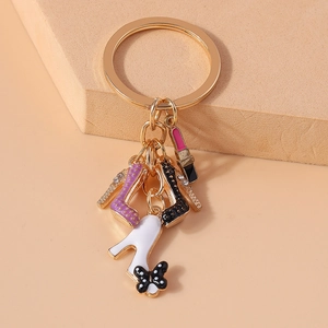 Detail of keychain featuring enamel high heels, lipstick and polka dot bow charms