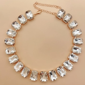 Detailed view of rectangular clear crystal necklace with gold metal base and lobster clasp